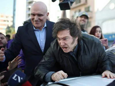 Argentina's President Javier Milei speaks to the media, while standing on a vehicle to attend a La Libertad Avanza party rally with lawmaker Jose Luis Espert, ahead of legislative elections in the province of Buenos Aires, in Lomas de Zamora on the outskirts of Buenos Aires, Argentina, August 27, 2025. REUTERS/Agustin Marcarian   TPX IMAGES OF THE DAY