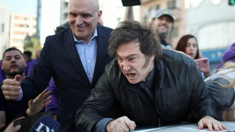 Argentina's President Javier Milei speaks to the media, while standing on a vehicle to attend a La Libertad Avanza party rally with lawmaker Jose Luis Espert, ahead of legislative elections in the province of Buenos Aires, in Lomas de Zamora on the outskirts of Buenos Aires, Argentina, August 27, 2025. REUTERS/Agustin Marcarian   TPX IMAGES OF THE DAY