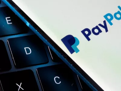 FILE PHOTO: A smartphone with the PayPal logo is placed on a laptop in this illustration taken on July 14, 2021. REUTERS/Dado Ruvic/File Photo