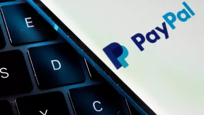 FILE PHOTO: A smartphone with the PayPal logo is placed on a laptop in this illustration taken on July 14, 2021. REUTERS/Dado Ruvic/File Photo