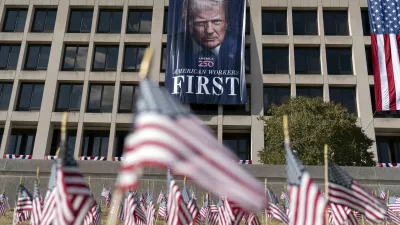 A portrait of President Donald Trump hangs on the Labor Department headquarters near the Capitol in Washington, Friday, Aug. 29, 2025. (AP Photo/Jose Luis Magana)