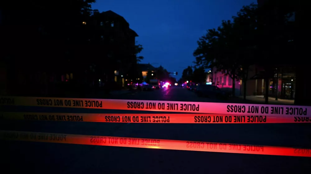 Emergency police lights illuminate a tape barrier near the scene of an attack that injured multiple people, in Boulder, Colorado, U.S. June 1, 2025. REUTERS/Mark Makela