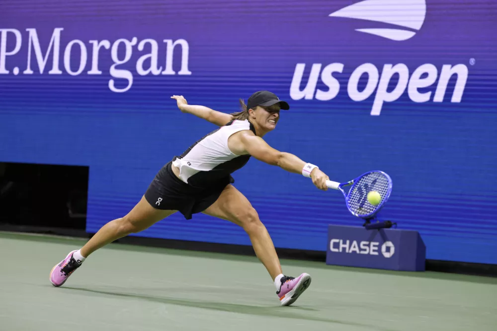 Iga Swiatek, of Poland, returns a shot against Anna Kalinskaya, of Russia, during the third round of the U.S. Open tennis championships, Saturday, Aug. 30, 2025, in New York. (AP Photo/Adam Hunger)
