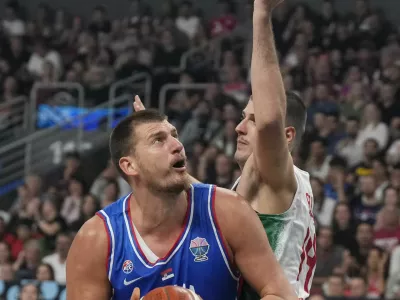 Basketball - FIBA EuroBasket 2025 - Group Phase - Portugal v Serbia - Xiaomi Arena, Riga, Latvia - August 29, 2025 Serbia's Nikola Jokic in action with Portugal's Daniel Relvao REUTERS/Ints Kalnins