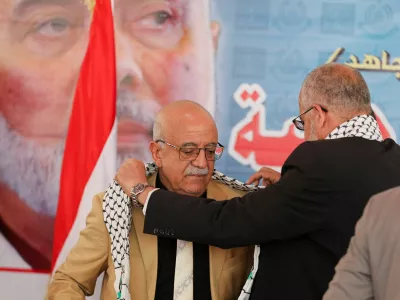 FILE PHOTO: Representative of Hamas in Yemen, Muadh Abu Shammalah, gives the head of Houthi-led government Ahmad al-Rahawi a Palestinian keffiyeh during his visit to the Hamas office in Sanaa, Yemen August 19, 2024. REUTERS/Khaled Abdullah/File Photo