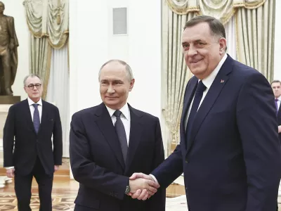 Russian President Vladimir Putin, center, and Bosnian Serb President Milorad Dodik shake hands during their meeting at the Kremlin in Moscow, Russia, Tuesday, April 1, 2025. (Mikhail Tereshchenko, Sputnik, Kremlin Pool Photo via AP)