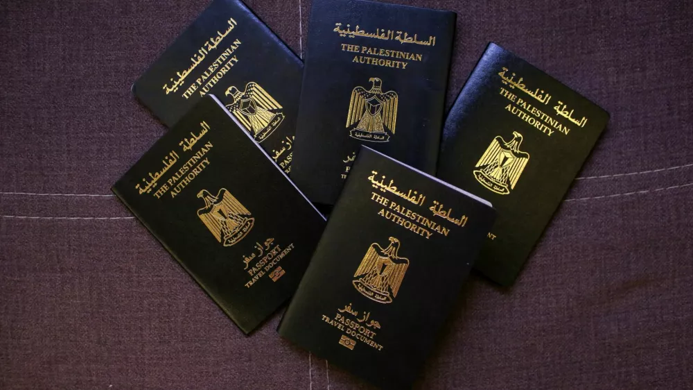Palestinian passports belonging to members of the Banat Gaza, which means "Girls of Gaza", a group of young women rebuilding their lives through cultural preservation with crafting handmade bags and selling traditional clothing that reflect their heritage, after fleeing the war in Khan Younis, Gaza, following the events of October 7, 2023, are displayed in Obour City, Egypt July 15, 2025. REUTERS/Hadeer Mahmoud