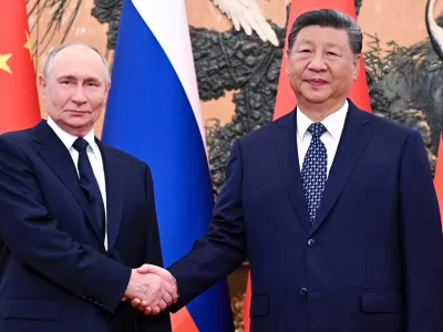 Russian President Vladimir Putin, left, and Chinese President Xi Jinping shake hands ahead of their meeting at The Great Hall of the People in Beijing, China, Tuesday, Sept. 2, 2025. (Sergei Bobylev, Sputnik, Kremlin Pool Photo via AP)