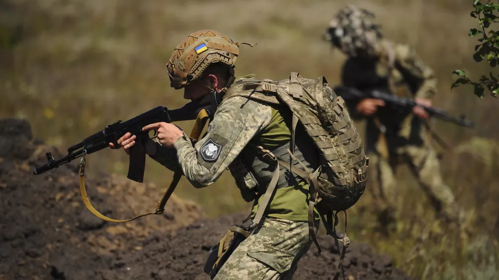 In this photo, taken on Tuesday, Aug. 19, 2025 and provided by Ukraine's 127th Separate Brigade of the Territorial Defence press service, soldiers aged 18 to 24 practice military skills on a training ground near Kharkiv, Ukraine. (Anatolii Lysianskyi/Ukraine's 127th Separate Brigade via AP)