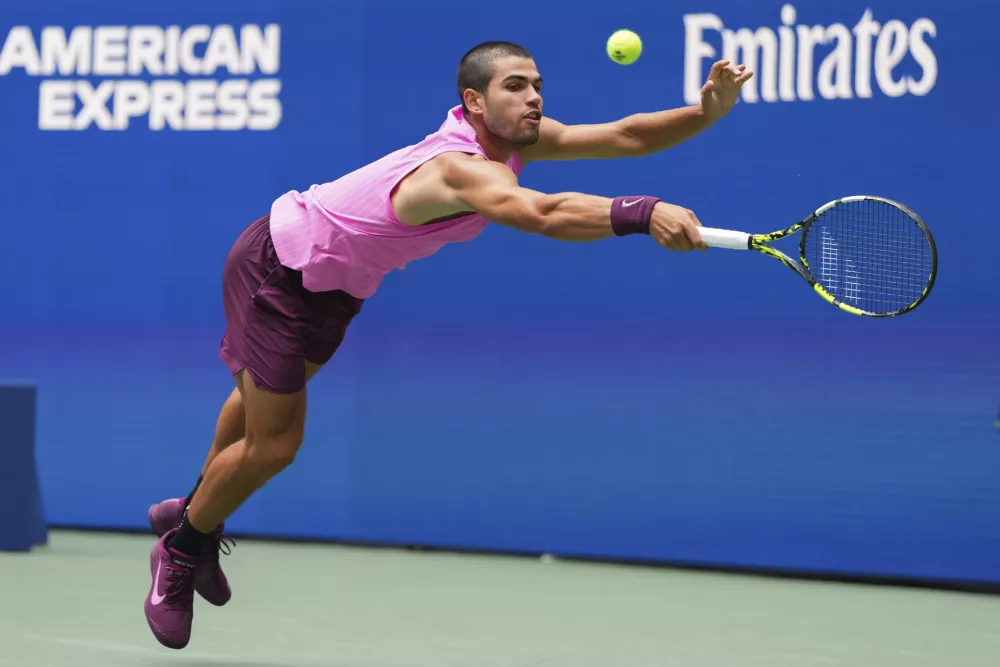Carlos Alcaraz, of Spain, returns a shot to Jiri Lehecka, of the Czech Republic, during the quarterfinal round of the U.S. Open tennis championships, Tuesday, Sept. 2, 2025, in New York. (AP Photo/Kirsty Wigglesworth)