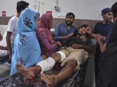Family members comfort an injured victim of suicide bombing who is receiving treatment at a hospital in Quetta, Pakistan, Tuesday, Sept. 2, 2025. (AP Photo/Arshad Butt)