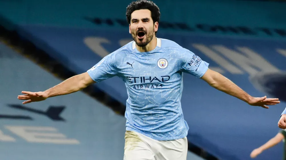 FILE - Manchester City's Ilkay Gundogan celebrates after scoring his side's third goal during the English Premier League soccer match between Manchester City and Tottenham Hotspur at Etihad Stadium in Manchester, England, on Feb. 13, 2021. (AP Photo/Rui Vieira, Pool File)