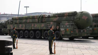 Members of the People's Liberation Army stand as the strategic strike group displays DF-61 nuclear missiles during a military parade to mark the 80th anniversary of the end of World War Two, in Beijing, China, September 3, 2025. REUTERS/Tingshu Wang