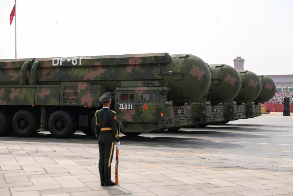 A member of the People's Liberation Army stands as the strategic strike group displays DF-61 nuclear missiles during a military parade to mark the 80th anniversary of the end of World War Two, in Beijing, China, September 3, 2025. REUTERS/Tingshu Wang