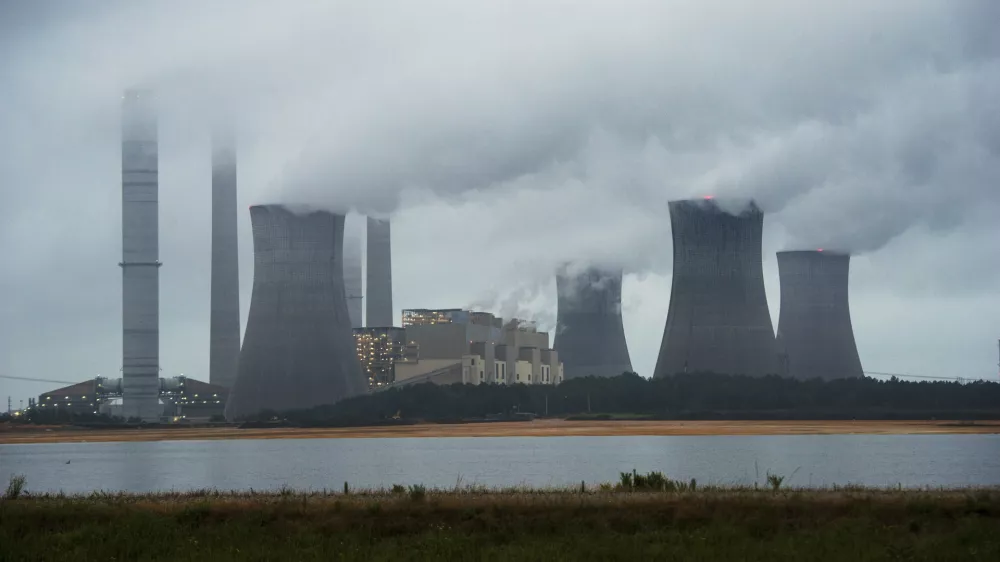 FILE - This June 1, 2014, file photo show the coal-fired Plant Scherer in operation in Juliette, Ga. Despite what President Donald Trump says, scientists have long known that what's warming the planet isn't natural. It's us. Climate scientists say Trump was wrong. There are several ways they know that more than 90 percent of climate change is caused by emissions of heat-trapping gases from activities like burning coal and natural gas for electricity, or burning gasoline, diesel and jet fuel for transportation. In other words, humans. (AP Photo/John Amis, File)