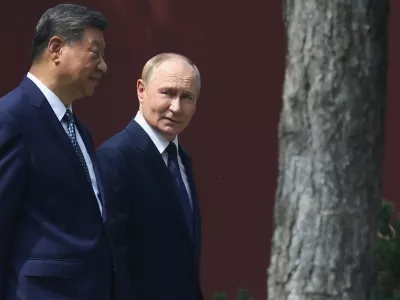 Russian President Vladimir Putin, right, speaks with Chinese President Xi Jinping during a walk at the Zhongnanhai leadership compound in Beijing, China, Tuesday, Sept. 2, 2025. (Alexander Kazakov, Sputnik, Kremlin Pool Photo via AP)