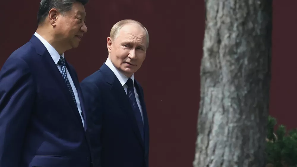 Russian President Vladimir Putin, right, speaks with Chinese President Xi Jinping during a walk at the Zhongnanhai leadership compound in Beijing, China, Tuesday, Sept. 2, 2025. (Alexander Kazakov, Sputnik, Kremlin Pool Photo via AP)