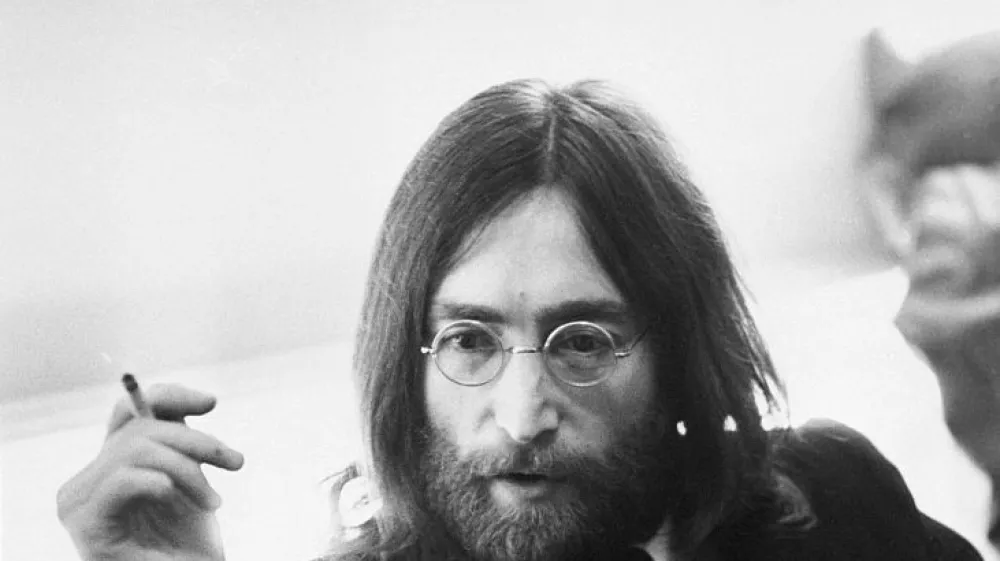 Musician John Lennon of the Beatles relaxing with a cigarette.