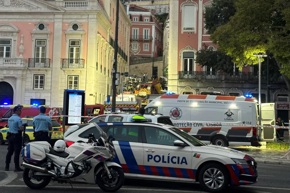 First responders work at the site of an accident at Lisbon's Gloria funicular, a popular tourist attraction, which derailed and crashed, resulting in fatalities and injuries, according to authorities, in Lisbon, Portugal, September 3, 2025. REUTERS/Miguel Pereira