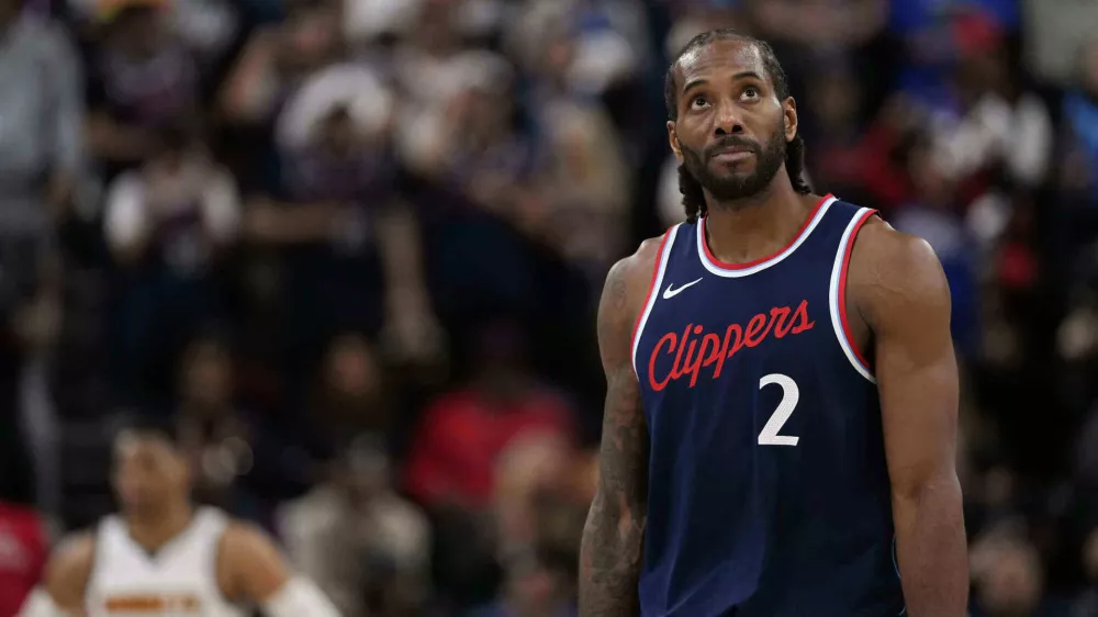 FILE - Los Angeles Clippers forward Kawhi Leonard, right, looks toward the scoreboard during the second half of an NBA basketball game, May 1, 2025, in Inglewood, Calif. (AP Photo/Mark J. Terrill, file)