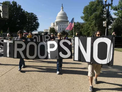 Demonstrators protest against President Donald Trump's use of federal law enforcement and National Guard troops in the city during protest at the U.S. Capitol, Tuesday, Sept. 2, 2025, in Washington. (AP Photo/Jose Luis Magana)