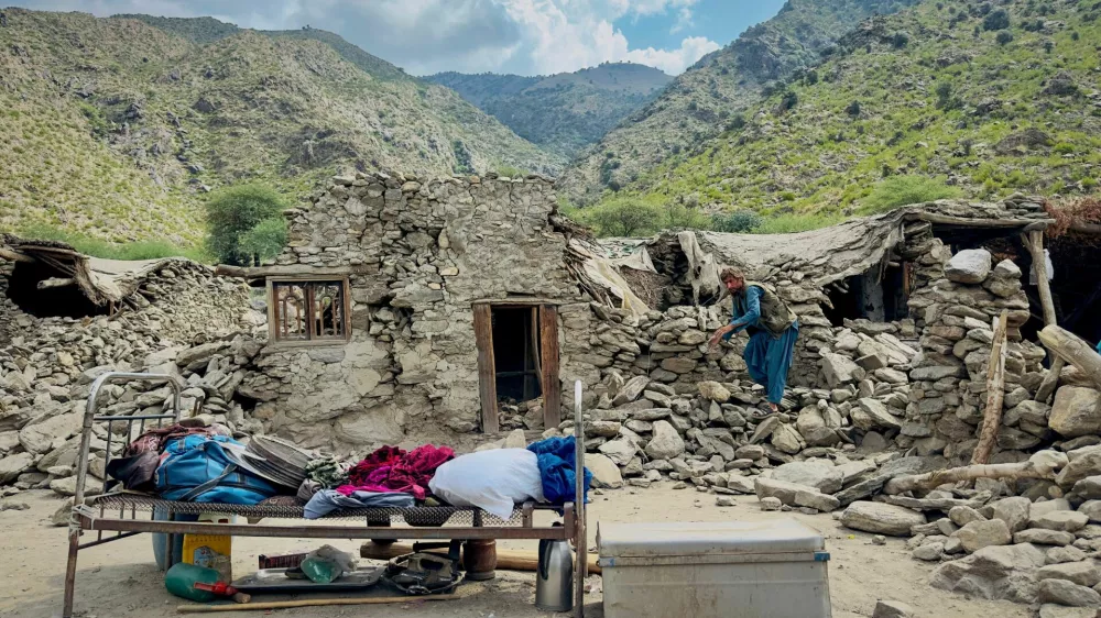An Afghan man looks for his belongings amidst the rubble of his collapsed house after a deadly magnitude 6 earthquake that struck Afghanistan on Sunday, at Lulam village, in Nurgal district, Kunar province, Afghanistan, September 3, 2025. REUTERS/Sayed Hassib