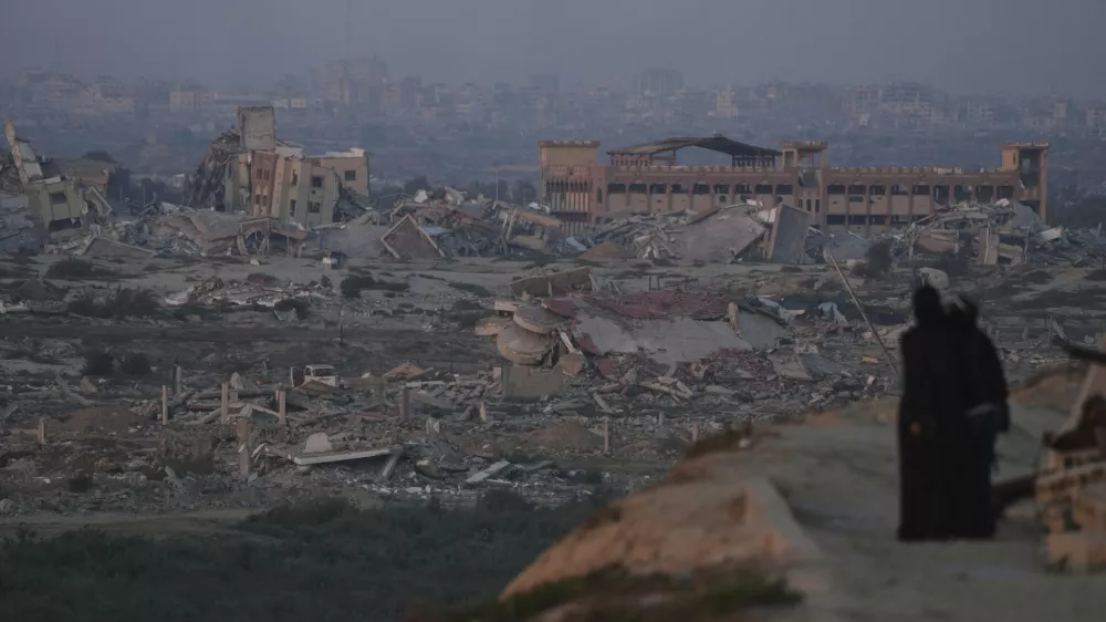 Palestinians look at the destruction caused by the Israeli air and ground offensive, in central Gaza Strip, Thursday, Sept. 4, 2025. (AP Photo/Jehad Alshrafi)