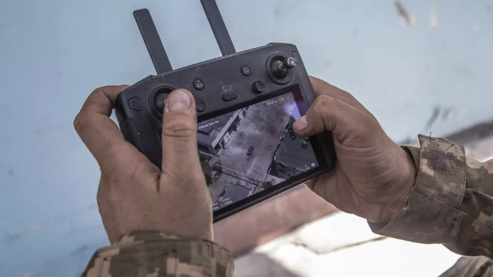 A Ukrainian soldier looks at a drone screen showing Russian troops positions during heavy fighting at the front line in Severodonetsk, Luhansk region, Ukraine, Wednesday, June 8, 2022. (AP Photo/Oleksandr Ratushniak)
