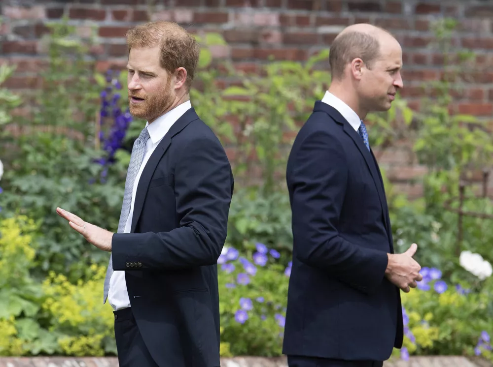 FILE - Prince Harry, left, and Prince William stand together during the unveiling of a statue they commissioned of their mother Princess Diana, on what would have been her 60th birthday, in the Sunken Garden at Kensington Palace, London, Thursday July 1, 2021. Prince Harry has said he wants to have his father and brother back and that he wants "a family, not an institution," during a TV interview ahead of the publication of his memoir. The interview with Britain's ITV channel is due to be released this Sunday. (Dominic Lipinski /Pool Photo via AP, File)