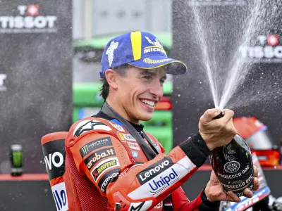 Winning Ducati Lenovo rider Marc Marquez of Spain, celebrates on the podium after the sprint of the MotoGP Hungarian Grand Prix at the Balaton Park Circuit in Balatonfokajar, Hungary, Saturday, Aug. 23, 2025. (Tamas Vasvari/MTI via AP)