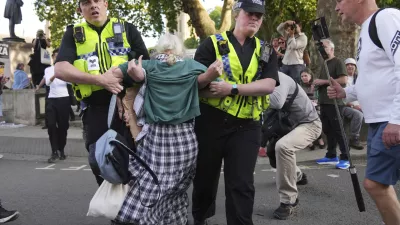 Police officers carry a protester during a protest to support Palestine Action in London, Saturday, Sept. 6, 2025.(AP Photo/Joanna Chan)