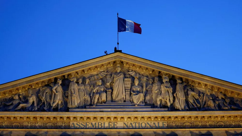 A French flag flutters on top of the National Assembly ahead of a confidence vote that the French Prime Minister Francois Bayrou seeks on the budget issue, in Paris, France, September 6, 2025. REUTERS/Abdul Saboor   TPX IMAGES OF THE DAY