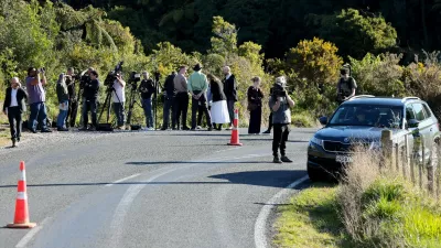 Members of the media stand on the side of a road where a police shootout occurred near the town of Piopio, located in New Zealand's Waikato region on September 8, 2025. A New Zealand father who spent nearly four years on the run with his children was killed in a police shootout on September 8, authorities said. Tom Phillips, who absconded with his three children in December 2021 after a row with his former partner, died in the rolling hill country of the North Island's Waikato region.,Image: 1035208608, License: Rights-managed, Restrictions:, Model Release: no