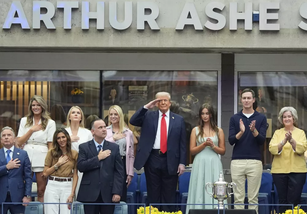 President Donald Trump, center, and others stand for the national anthem before the US Open tennis men's singles final Sunday, Sept. 7, 2025, in Flushing, N.Y. (AP Photo/Manuel Balce Ceneta)