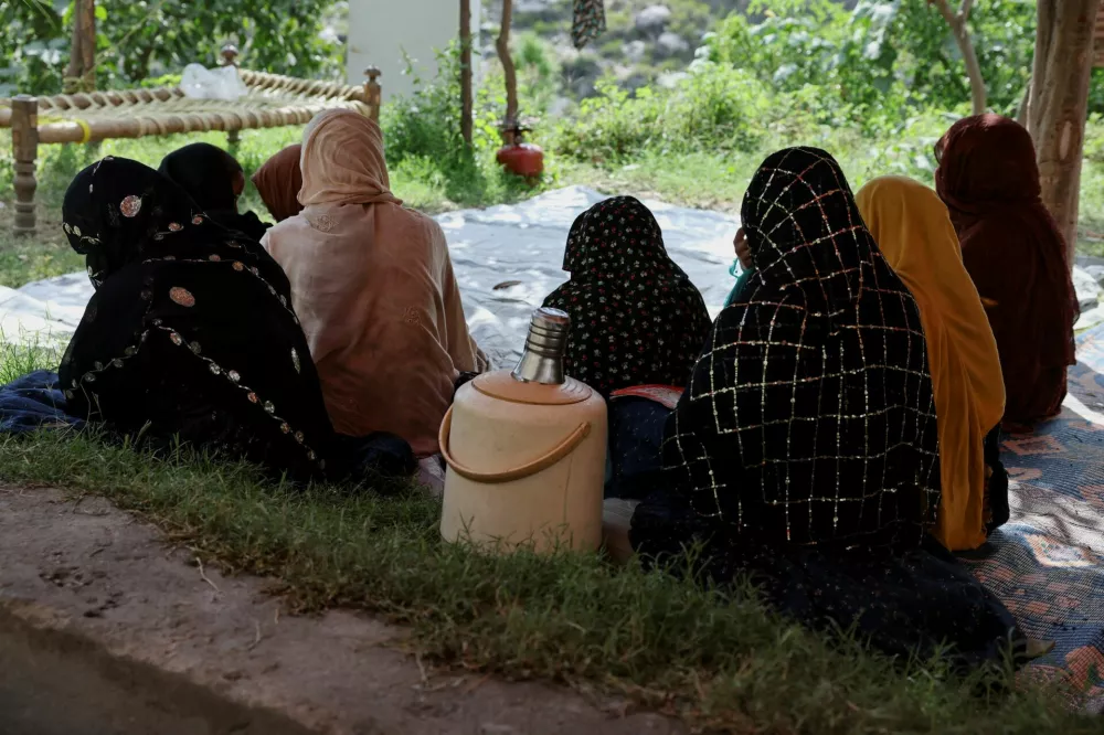 Women sit inside a tent while taking refuge with others following the deadly earthquake in Bambakot village, Dera Noor district, Nangarhar province, Afghanistan, September 6, 2025. REUTERS/Sayed Hassib