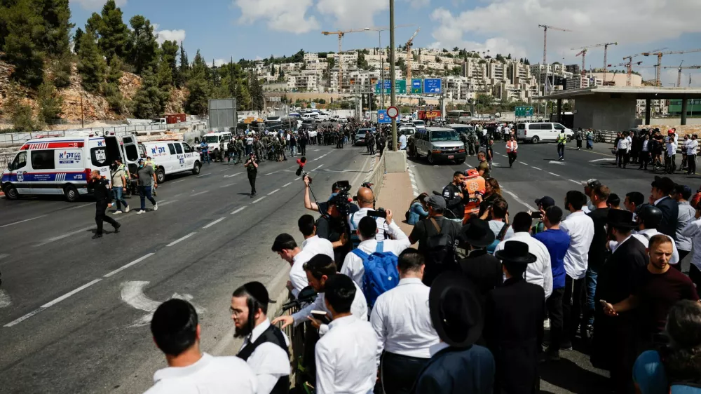 People gather near the scene where a suspected shooting attack took place at the outskirts of Jerusalem, September 8, 2025 REUTERS/Ammar Awad