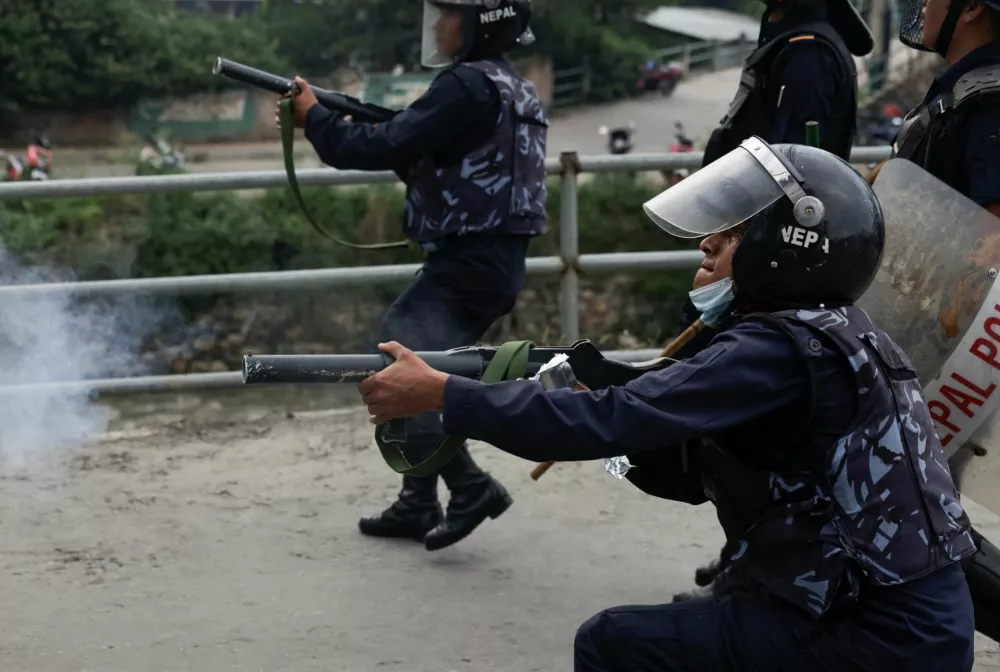 A riot police officer fires teargas towards the demonstrators during a protest against corruption and the government's decision to block several social media platforms, in Kathmandu, Nepal, September 8, 2025. REUTERS/Navesh Chitrakar