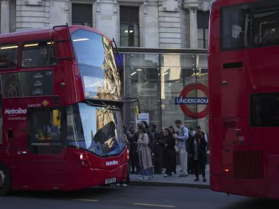 People queue for buses in London during a strike by members of the Rail, Maritime and Transport union (RMT), in central London, Monday, Sept. 8, 2025. (AP Photo/Joanna Chan)