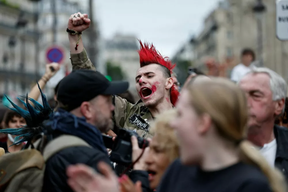 A protester raises his fist during a demonstration near the Gare du Nord train station during a day of protests in Paris as part of a grassroots protest movement called "Bloquons Tout" ("Let's Block Everything") calling for nationwide all-day disruptions, France, September 10, 2025.  REUTERS/Benoit Tessier