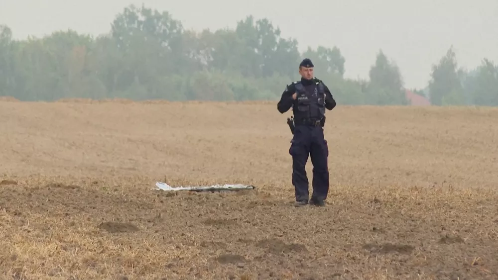A Polish police officer stands near a unmanned aerial vehicle (UAV) fragment, after Russian drones violated Polish airspace during an attack on Ukraine and some were shot down by Poland, in Czesniki, Lublin Voivodeship, Poland, September 10, 2025 in this still image from video. Polsat News via REUTERS  THIS IMAGE HAS BEEN SUPPLIED BY A THIRD PARTY. POLAND OUT. NO COMMERCIAL OR EDITORIAL SALES IN POLAND   TPX IMAGES OF THE DAY