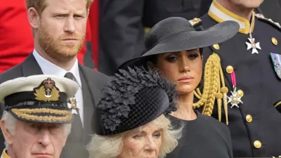 Britain's King Charles III, from bottom left, Camilla, the Queen Consort, Prince Harry and Meghan, Duchess of Sussex watch as the coffin of Queen Elizabeth II is placed into the hearse following the state funeral service in Westminster Abbey in central London Monday Sept. 19, 2022. The Queen, who died aged 96 on Sept. 8, will be buried at Windsor alongside her late husband, Prince Philip, who died last year. (AP Photo/Martin Meissner, Pool)