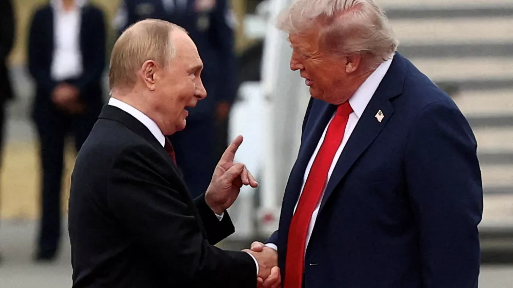 FILE PHOTO: U.S. President Donald Trump shakes hand with Russian President Vladimir Putin, as they meet to negotiate for an end to the war in Ukraine, at Joint Base Elmendorf-Richardson in Anchorage, Alaska, U.S., August 15, 2025. REUTERS/Kevin Lamarque/File Photo