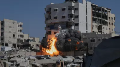 Smoke and flames rise from an Israeli military strike on a building in Gaza City, Friday, Sept. 12, 2025. (AP Photo/Yousef Al Zanoun)