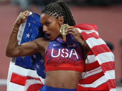 14 September 2025, Japan, Tokyo: USA's Tara Davis-Woodhall poses for a photo with her Gold Medal after winning the Woman's Long Jump Final on Day Two of the World Athletics Championships Tokyo 2025 at National Stadium. Photo: Oliver Weiken/dpa