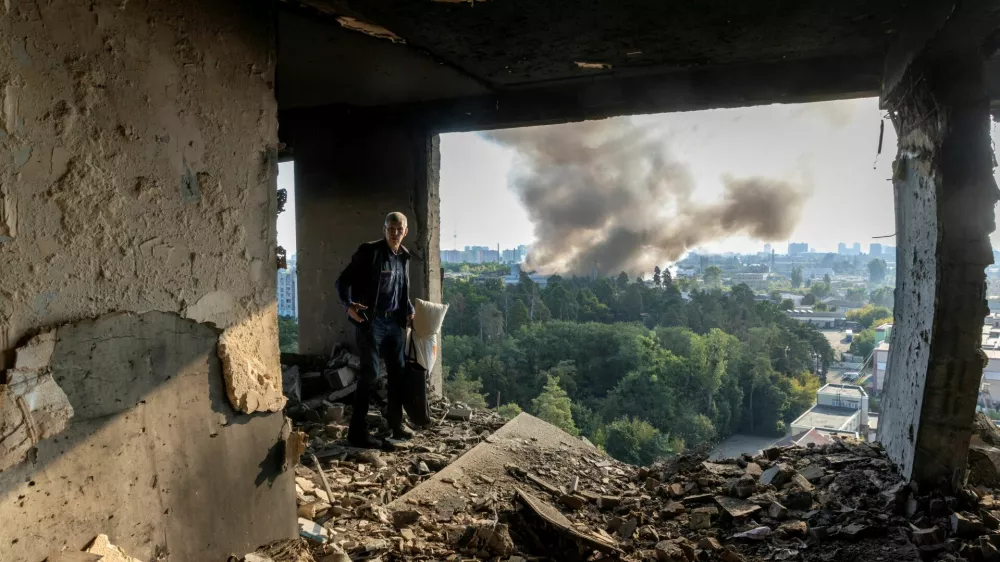 A friend of the owner inspects the damage in an apartment that was hit during a Russian drone strike, amid Russia's attack on Ukraine, in Kyiv, Ukraine September 7, 2025. REUTERS/Thomas Peter    TPX IMAGES OF THE DAY