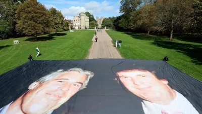 A large banner depicting U.S. President Donald Trump alongside disgraced financier Jeffrey Epstein is displayed near the Windsor Castle by campaign group 'Everyone Hates Elon', protesting Trump's state visit to the country, in Windsor, Britain, September 15, 2025. REUTERS/Hannah McKay REFILE - CORRECTING NAME OF CAMPAIGN GROUP FROM "EVERYBODY HATES ELON" TO "EVERYONE HATES ELON".