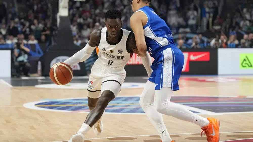 Basketball - FIBA EuroBasket 2025 - Semi Finals - Germany v Finland - Xiaomi Arena, Riga, Latvia - September 12, 2025 Germany's Dennis Schroder in action with Finland's Miro Little REUTERS/Ints Kalnins