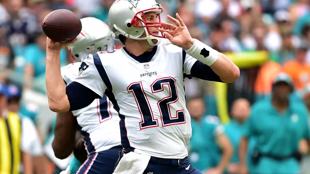 Dec 9, 2018; Miami Gardens, FL, USA; New England Patriots quarterback Tom Brady (12) throws a pass against the Miami Dolphins during the first half at Hard Rock Stadium. Mandatory Credit: Steve Mitchell-USA TODAY Sports