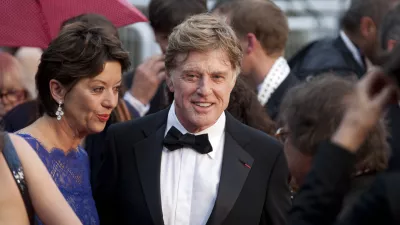 Actor Robert Redford, centre, and his wife Sibylle Szaggars, centre left, arrive for the screening of All Is Lost at the 66th international film festival, in Cannes, southern France, Wednesday, May 22, 2013. (AP Photo/Virginia Mayo)