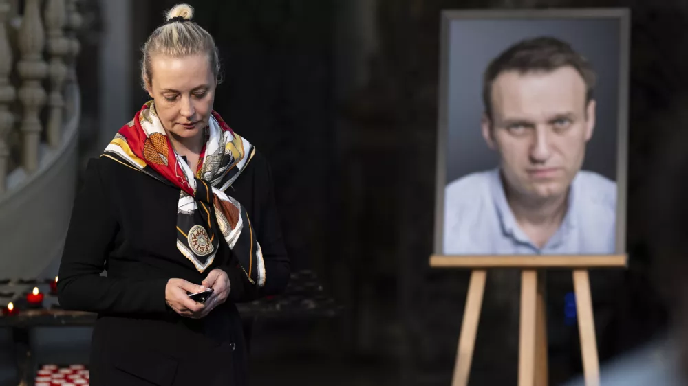 FILE -Yulia Navalnaya, widow of Russian opposition leader Alexei Navalny walks away from his picture after lighting a candle at the end of a service in St. Mary's Church on the occasion of his birthday, in Berlin, June 4, 2024. (Christoph Gollnow/dpa/dpa via AP, File)